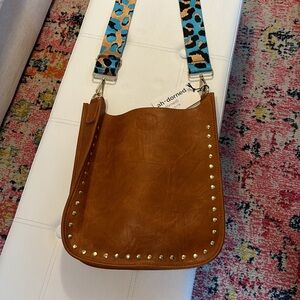 Ahdorned messenger bag with strap